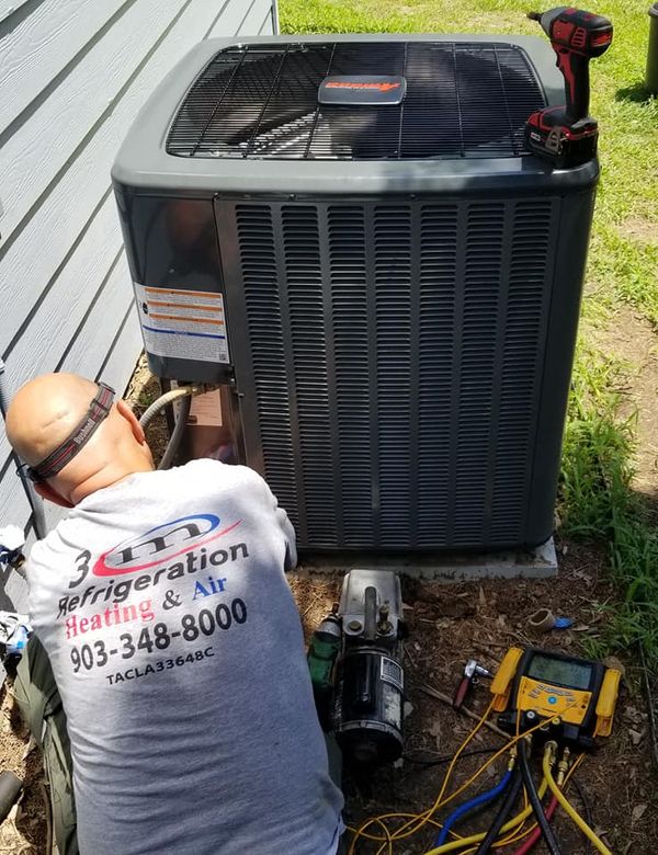HVAC technician repairing AC in Winnsboro